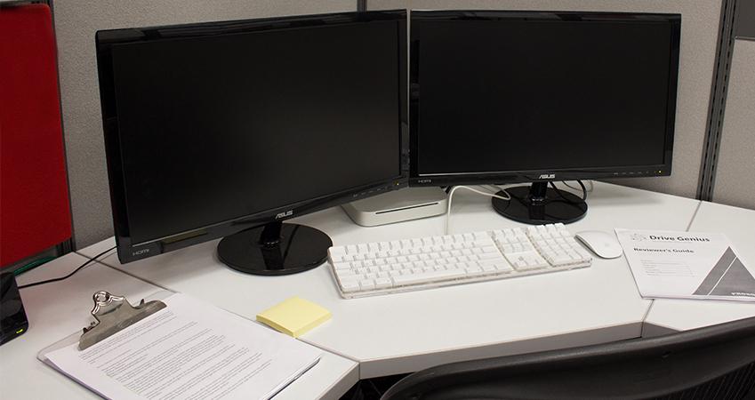 A messy computer cubical ready to be cleaned.