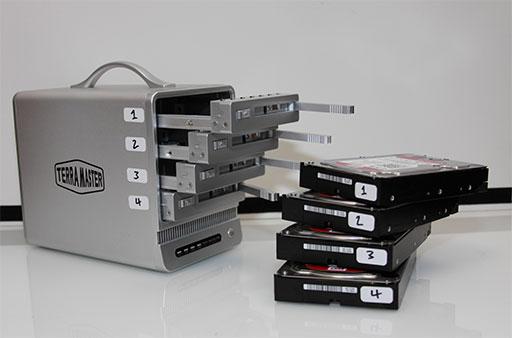 Showing a Terra Master RAID box with a all the drives labeled in order and out of the enclosure.